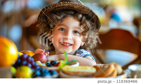 Joyful child enjoying a healthy breakfast with fruits and pastries in a cozy setting 118368466