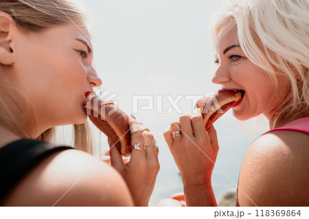 Two Women Enjoying a Delicious Meal Together 118369864