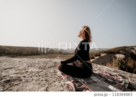 Woman Meditating on a Clifftop with a View 118369865