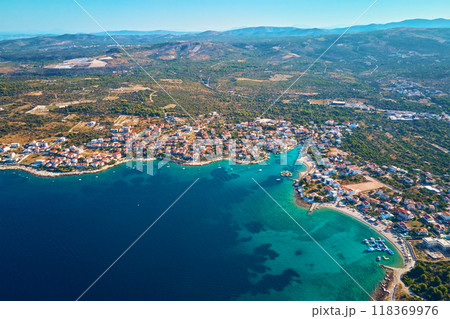 Islands in sea covered with lush greenery and houses, aerial view. Touristic place for summer vacation. Panoramic landscape of Adriatic sea coastline near Rogoznica town in Dalmatian region, Croatia 118369976