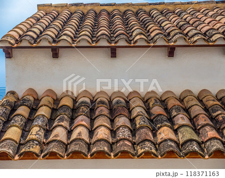 Traditional Mediterranean style terracotta roof with curved, clay tiles 118371163