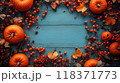 Halloween background for your text, frame of orange pumpkins, berries and leaves on blue wooden table, top view. Concept of design, food, flat lay, thanksgiving, autumn. 118371773