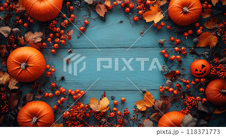 Halloween background for your text, frame of orange pumpkins, berries and leaves on blue wooden table, top view. Concept of design, food, flat lay, thanksgiving, autumn. 118371773