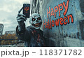 Scary dead zombie makes selfie with mobile phone against Happy Halloween text on building wall. Concept of apocalypse, horror, party, spooky person. 118371782