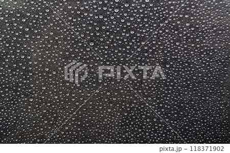 Rain water droplets on dark cover background. Water droplets and wallpaper concept Rain water droplets on dark cover background. Water droplets and wallpaper concept 118371902