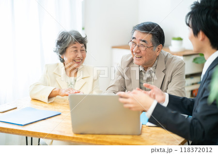 リフォーム相談をするシニア夫婦　シニア夫婦に営業するビジネスマン 118372012
