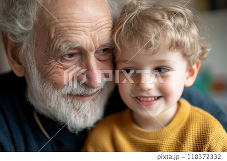 Smiling grandfather holding his young grandson Smiling grandfather holding his young grandson 118372332