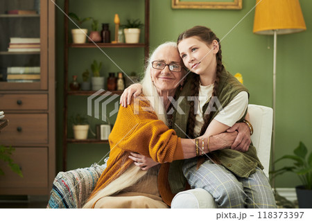 Embracing Moment Between Elderly Woman and Young Girl 118373397