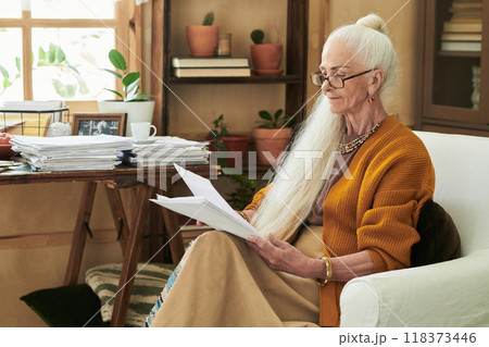 Reading Documents at Cozy Home Office Space Reading Documents at Cozy Home Office Space 118373446