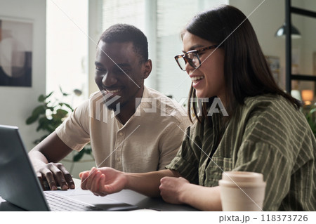 Collaborating on Project in Modern Office Setting 118373726