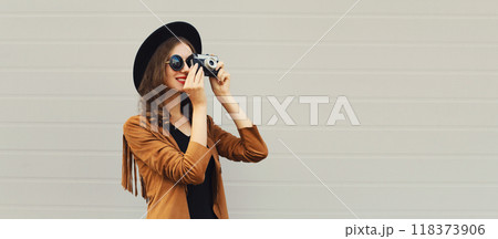 Beautiful happy woman photographer taking picture with camera, stylish creative modern girl 118373906