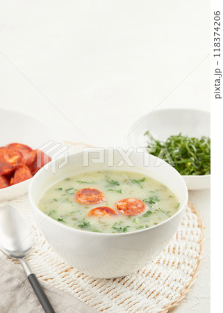 Typical Portuguese soup Caldo Verde with bread and cabbage on white background Typical Portuguese soup Caldo Verde with bread and cabbage on white background 118374206