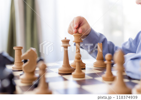 little boy is playing chess at home little boy is playing chess at home 118374939
