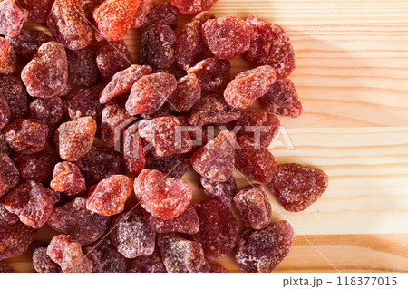Dried red strawberry berries on wooden surface, nobody Dried red strawberry berries on wooden surface, nobody 118377015