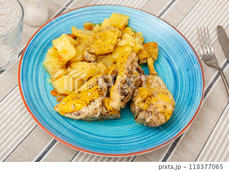 Baked chicken drumsticks and potatoes at plate closeup Baked chicken drumsticks and potatoes at plate closeup 118377065