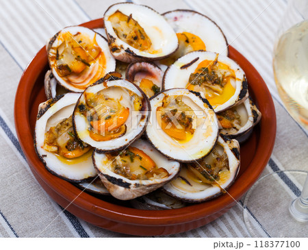 Baked in oven with sauce open seashell served at white plate Baked in oven with sauce open seashell served at white plate 118377100