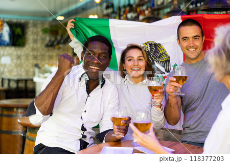 Joyful fans of the Mexican team celebrating the victory in night bar Joyful fans of the Mexican team celebrating the victory in night bar 118377203