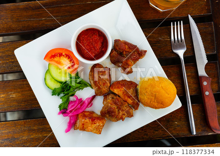 Barbecued pork shashlik with onion and herbs 118377334