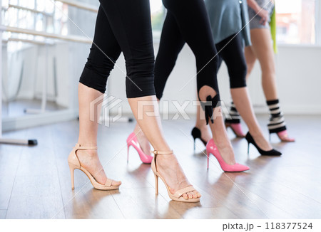 Women's legs in high heels in dance studio Women's legs in high heels in dance studio 118377524