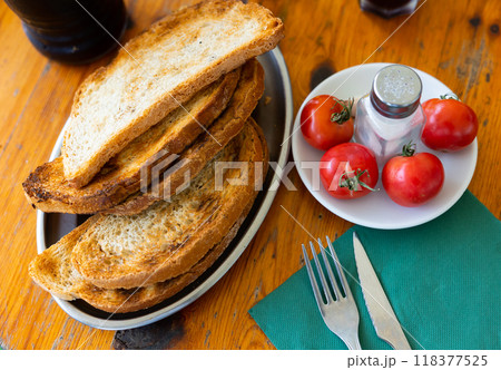 Toast served on platter with tomatoes Toast served on platter with tomatoes 118377525
