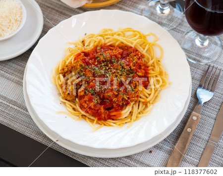 Italian bolonesa, bolognese noodles with tomato sauce and cheese in cafe Italian bolonesa, bolognese noodles with tomato sauce and cheese in cafe 118377602