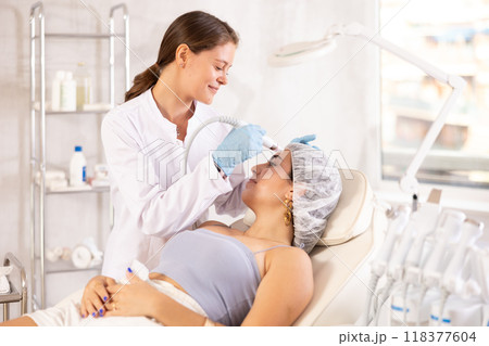 European doctor making Beauty procedure to brunette girl (skin cleaning) European doctor making Beauty procedure to brunette girl (skin cleaning) 118377604