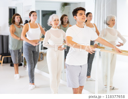 Concentrated women and men rehearsing ballet dance in dance studio Concentrated women and men rehearsing ballet dance in dance studio 118377658