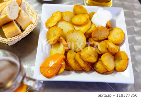 Delicious baked in oven yellow spicy potatoes bravas served 118377850