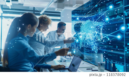 A group of people are working on a computer screen with a map of the world 118378092