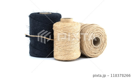 Assorted jute and twine spools on white background showcasing natural fiber materials Assorted jute and twine spools on white background showcasing natural fiber materials 118378266