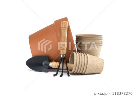 Gardening tools with terracotta pot, biodegradable pots, and spool of twine on a white background Gardening tools with terracotta pot, biodegradable pots, and spool of twine on a white background 118378270