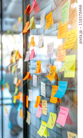 A wall covered in colorful sticky notes with various words A wall covered in colorful sticky notes with various words 118378466