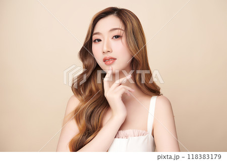 Beautiful young asian woman with clean fresh skin on beige background, Face care, Facial treatment, Cosmetology, beauty and spa, Asian women portrait. Beautiful young asian woman with clean fresh skin on beige background, Face care, Facial treatment, Cosmetology, beauty and spa, Asian women portrait. 118383179