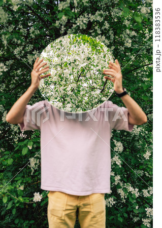Creative male portrait with mirror in blooming apples spring garden Creative male portrait with mirror in blooming apples spring garden 118383536