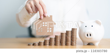 Money Saving, Property investment, House Mortgage, Loan and Real Estate Financial concepts. woman with coins stack piggy bank and Home model, Money stack Counting arrangement for deposit and Tax 118383780