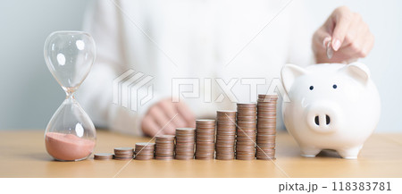 Money Saving for Future Plan, Retirement fund, Pension, Investment, Wealth Business and Financial concepts. coins stack, piggy bank with sandglass on table 118383781