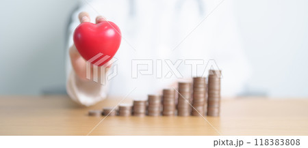 Money Saving, Health Insurance, Medical, Donation and Financial concepts. Doctor with coins stack and Heart on table. Money stack Counting arrangement for deposit and Healthcare cost 118383808