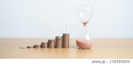 Money Saving for Future Plan, Retirement fund, Pension, Investment, Wealth Business and Financial concepts. hand putting coin on money stack with sandglass 118383820