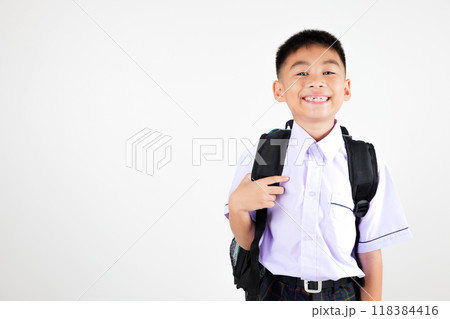 Portrait smiling Asian little boy primary posing with schoolbag phone studio shot isolated white background, happy cute man kid wear school uniform and backpack, back to school concept 118384416