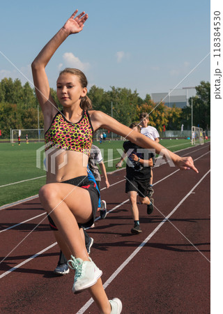 Group of young athletes training at the stadium Group of young athletes training at the stadium 118384530