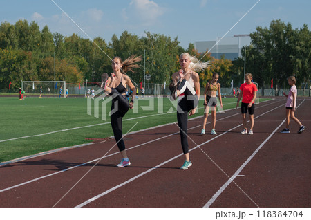 Group of young athletes training at the stadium 118384704