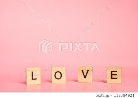 The word love made up of individual letters on a pink background with copy space. Valentine's Day concept The word love made up of individual letters on a pink background with copy space. Valentine's Day concept 118384921