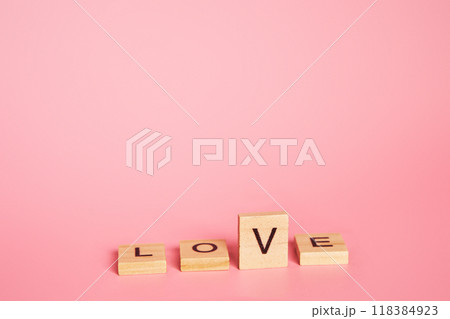 Love is a choice concept. The word love on a pink background with copy space. letter v like a tick. Love is a choice concept. The word love on a pink background with copy space. letter v like a tick. 118384923