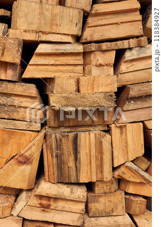 Sawmill work. Cuttings of boards, timber. Wooden cuts different shapes and sizes. Yellow brown construction background. Sawmill work. Cuttings of boards, timber. Wooden cuts different shapes and sizes. Yellow brown construction background. 118384927