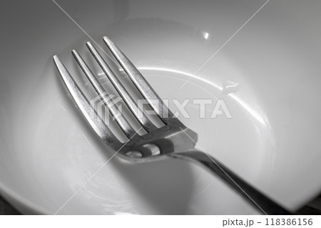 A fork in a plate 118386156