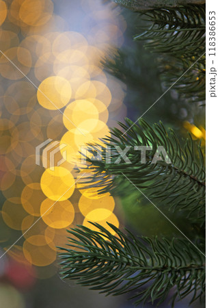 Christmas tree. Christmas lights and fir branches. Christmas texture for postcards.Out of focus. 118386653