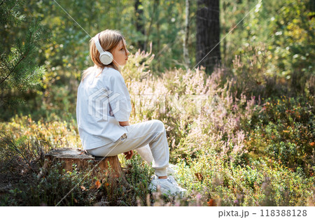 A teenage girl who breathes fresh air and relieves stress in the forest. 118388128