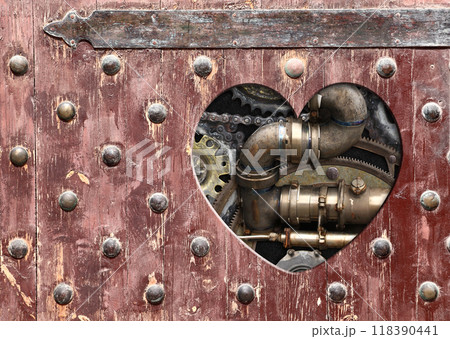Retro background in steampunk style with heart-shaped hole in wooden boards and vintage metal machine details, pipeline, gear. Copy space for text. Can be used for industrial, mechanical design 118390441