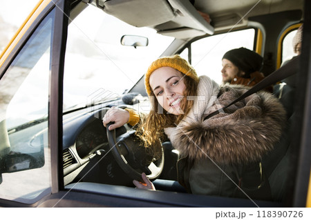 Friends going skiing at ski resort, spending the Christmas holidays together in a cabin. Driving car through a snowy landscape. Friends going skiing at ski resort, spending the Christmas holidays together in a cabin. Driving car through a snowy landscape. 118390726