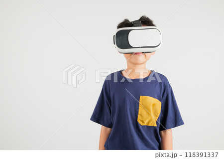 Smiling young kid boy confidence excited wear VR headset device during virtual reality experience isolated white background, Asian happy portrait primary child playing video game studio shot Smiling young kid boy confidence excited wear VR headset device during virtual reality experience isolated white background, Asian happy portrait primary child playing video game studio shot 118391337